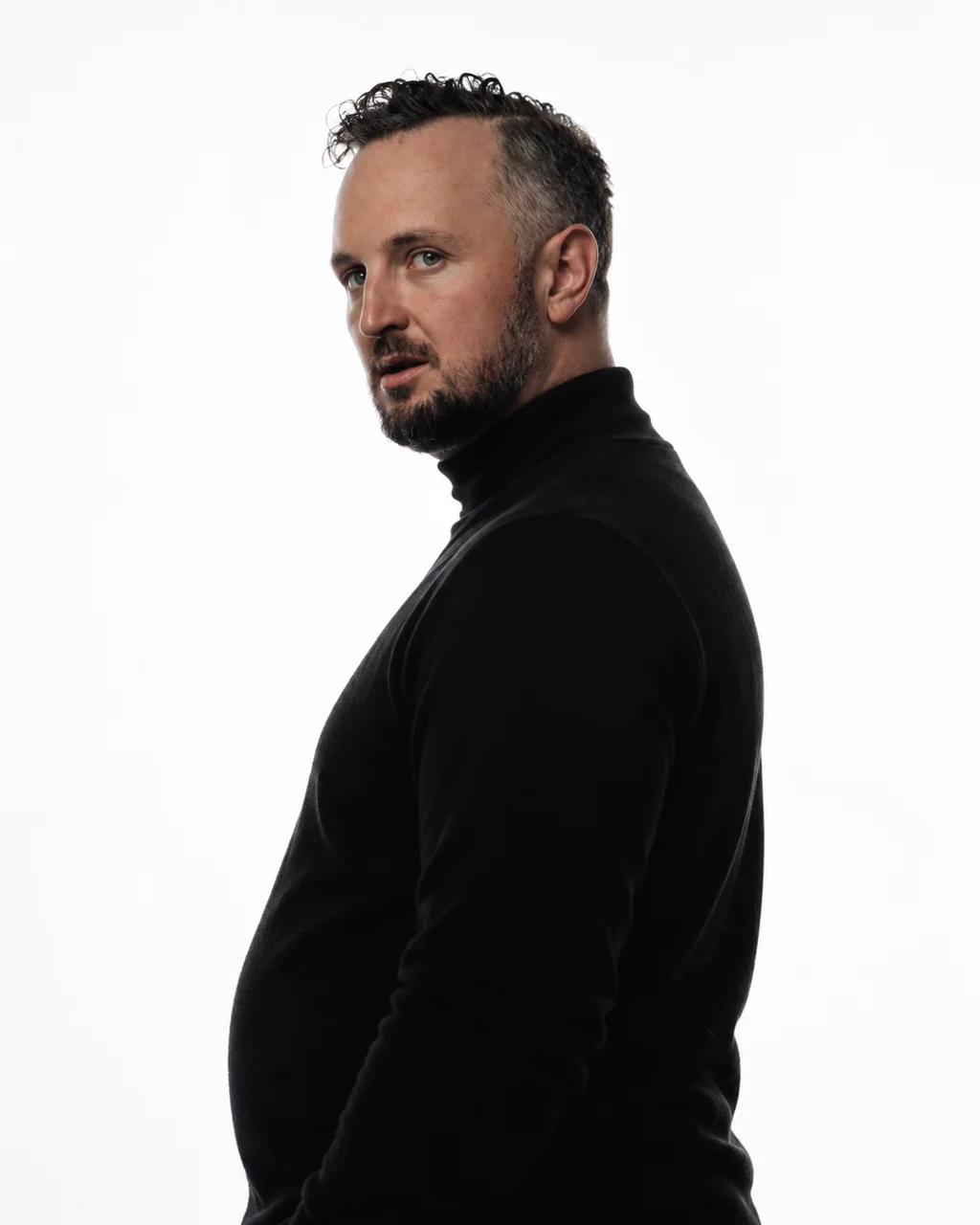 Michael posing in a black turtleneck
